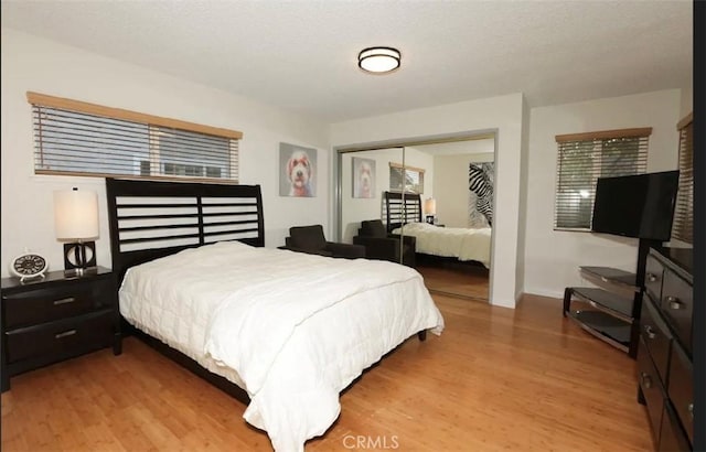 bedroom with a closet and light hardwood / wood-style flooring