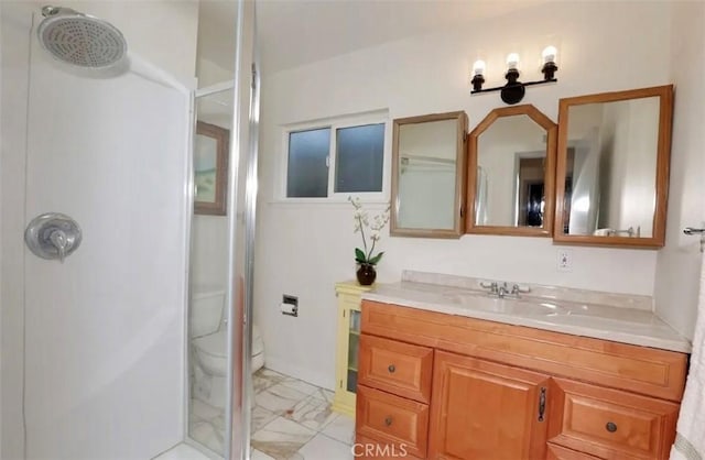 bathroom featuring toilet, walk in shower, and vanity