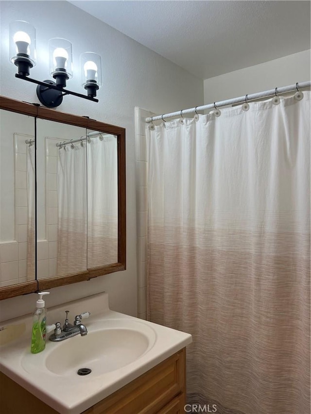 bathroom featuring vanity and a shower with shower curtain