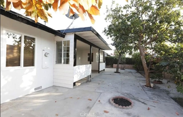 view of side of property with a patio