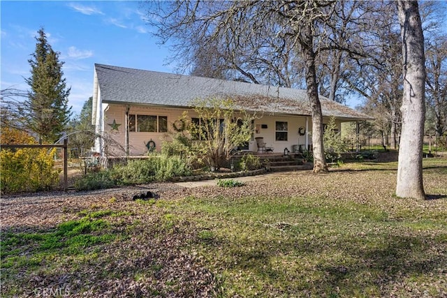 back of house with a lawn