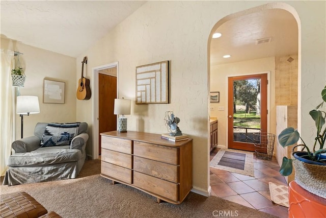 foyer featuring lofted ceiling and light tile patterned floors