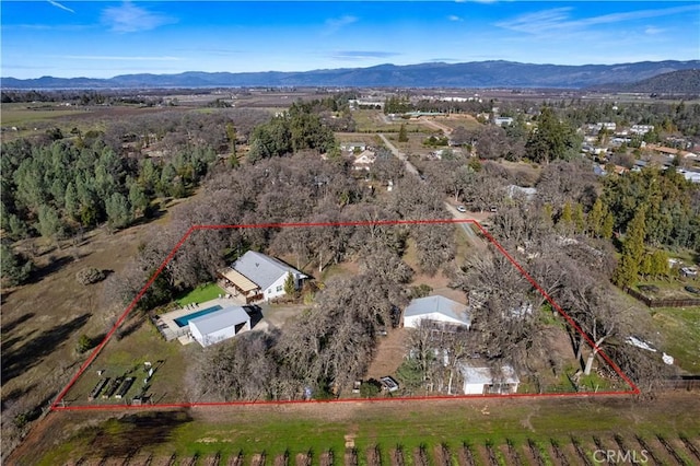 drone / aerial view featuring a mountain view and a rural view