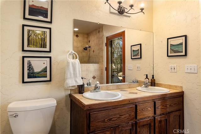 bathroom with toilet, vanity, and a notable chandelier