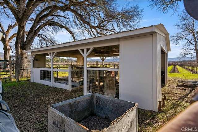 exterior space with an outbuilding and a rural view