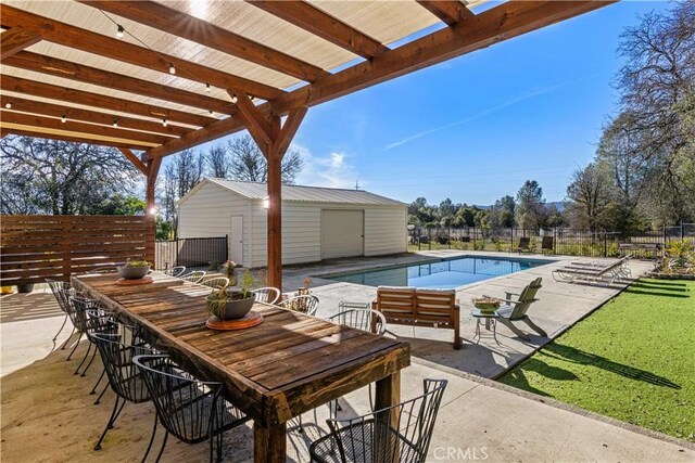 view of pool with a storage unit, a pergola, and a patio