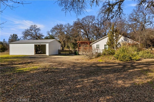 view of yard with a garage and an outdoor structure