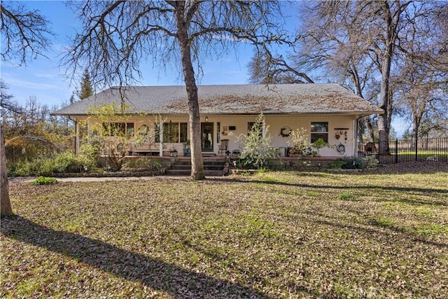 view of front of property featuring covered porch and a front yard