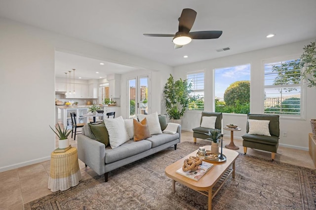 living room with ceiling fan and light tile patterned floors