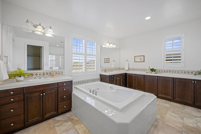 bathroom featuring a healthy amount of sunlight, decorative backsplash, and vanity