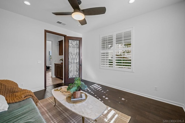 living area featuring ceiling fan and hardwood / wood-style flooring