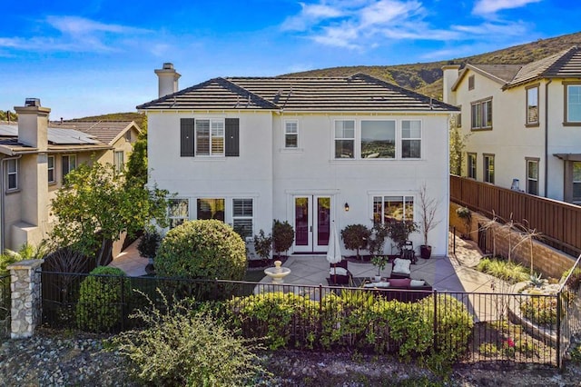 back of property featuring a patio area and french doors