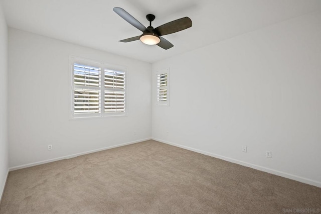 empty room with light colored carpet and ceiling fan