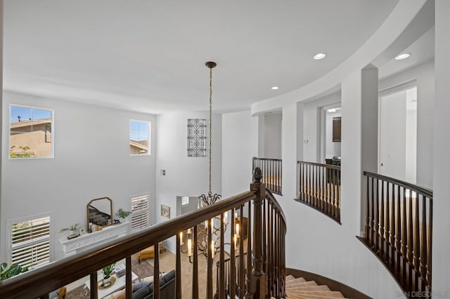 corridor with an inviting chandelier