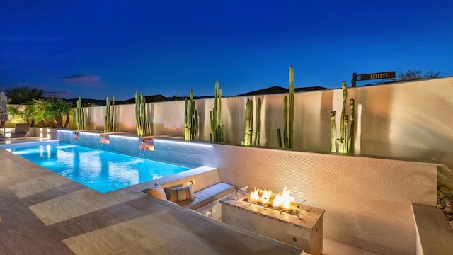 view of swimming pool with a fire pit