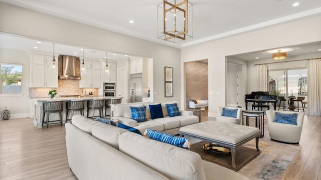 living room with a notable chandelier and light wood-type flooring