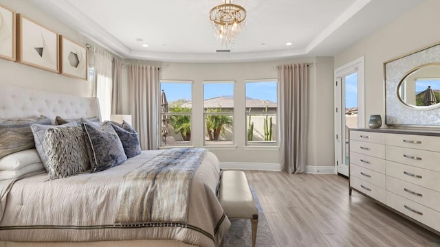 bedroom featuring an inviting chandelier and light hardwood / wood-style floors