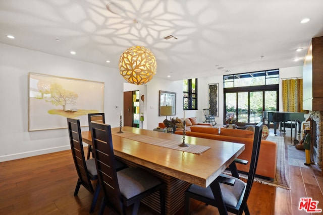 dining space featuring dark wood-type flooring