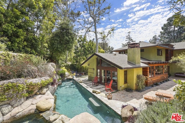 view of swimming pool with a patio area and french doors