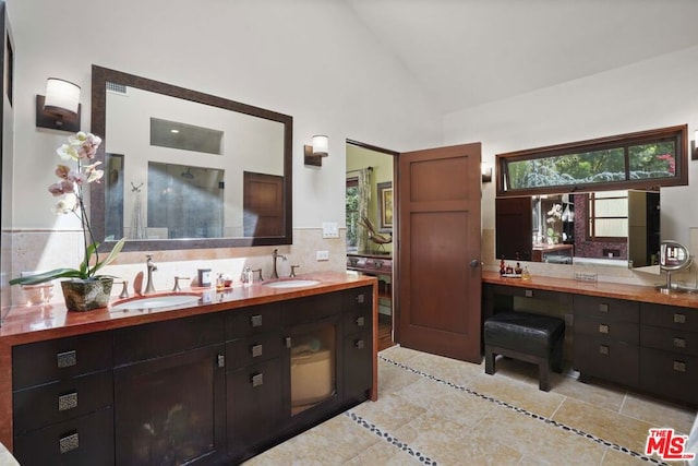 bathroom with vanity and high vaulted ceiling