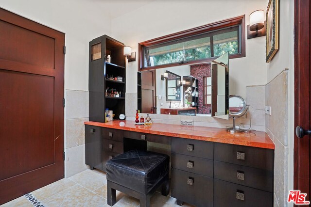 tiled home office featuring tile walls