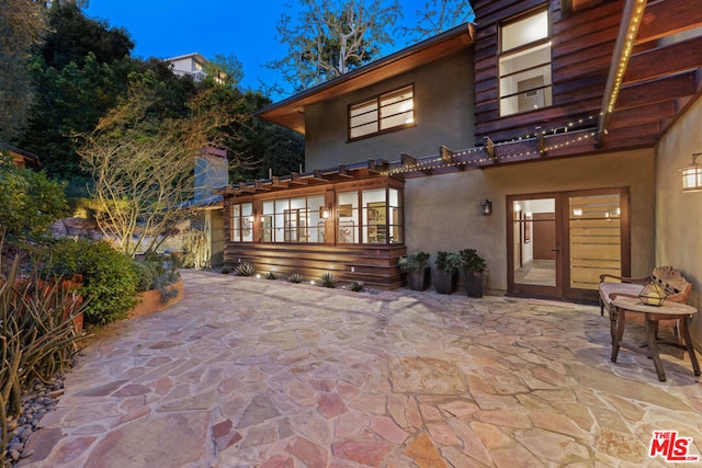 rear view of property with a patio area and french doors