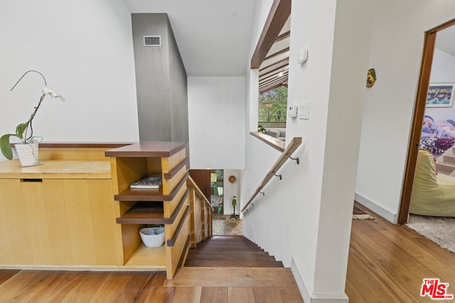 stairway featuring hardwood / wood-style floors