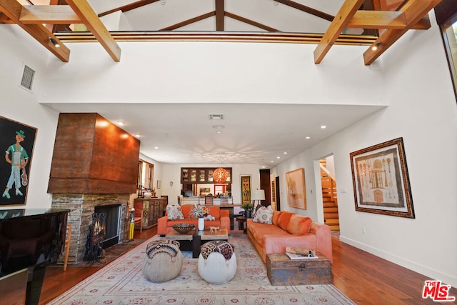 living room with wood-type flooring and a high ceiling