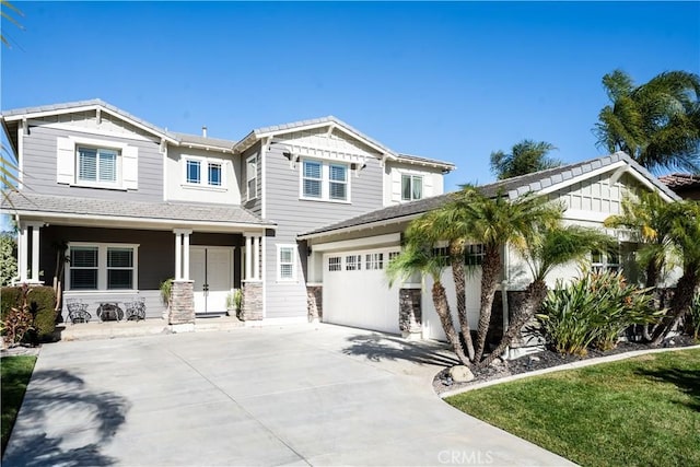 craftsman inspired home featuring a porch and a garage