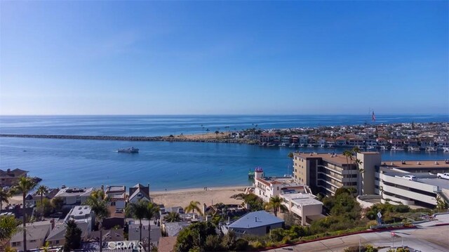 bird's eye view featuring a water view and a beach view