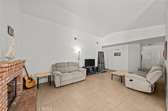 living room featuring vaulted ceiling and a brick fireplace