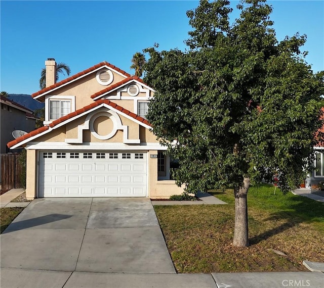 view of front of house with a front yard and a garage