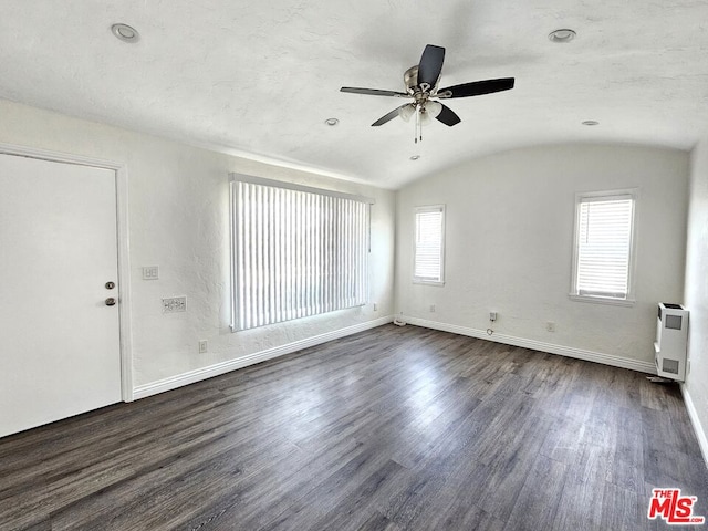 interior space featuring lofted ceiling, brick ceiling, ceiling fan, and dark wood-type flooring