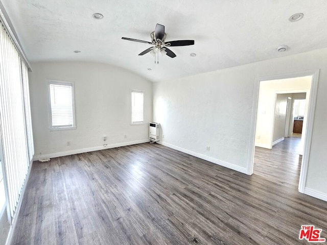 spare room featuring vaulted ceiling, brick ceiling, dark hardwood / wood-style floors, and ceiling fan