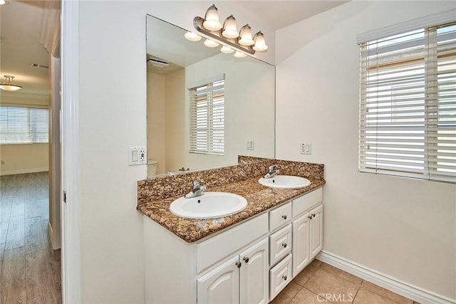 bathroom with tile patterned flooring, vanity, and toilet