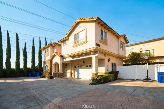 mediterranean / spanish home featuring a garage