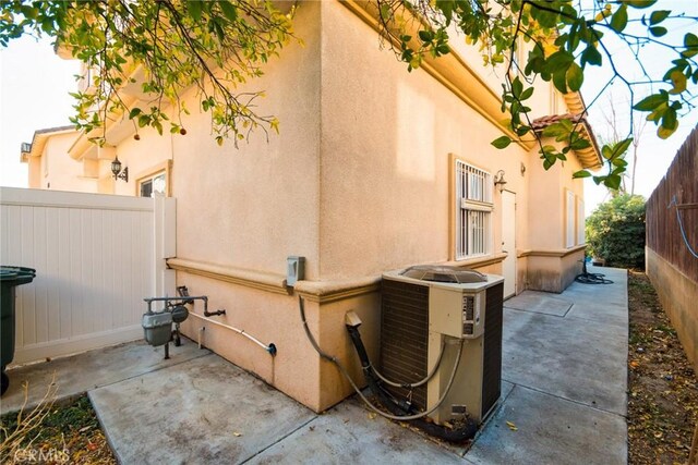 view of home's exterior with central air condition unit and a patio