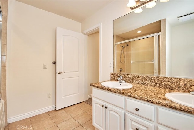 bathroom featuring vanity, tile patterned floors, and a shower with shower door