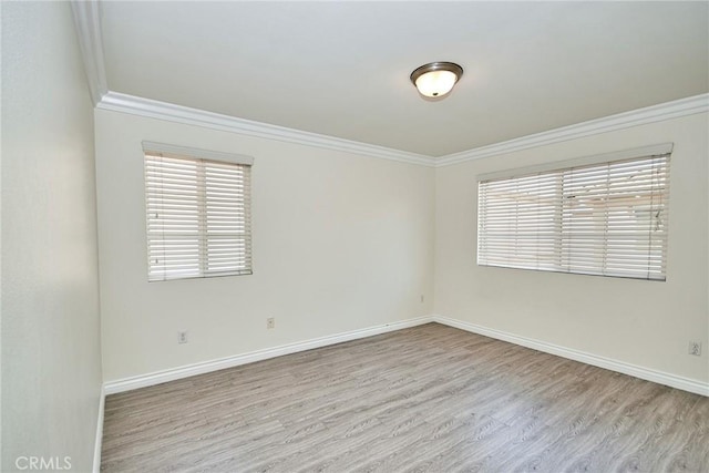 unfurnished room with crown molding and light hardwood / wood-style flooring