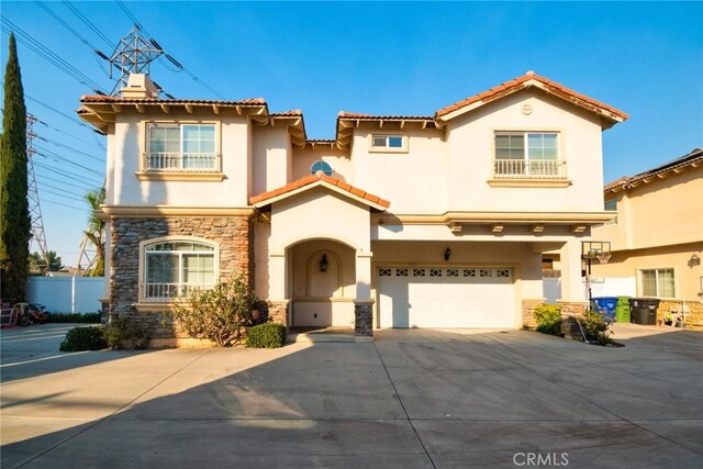 mediterranean / spanish-style house featuring a garage