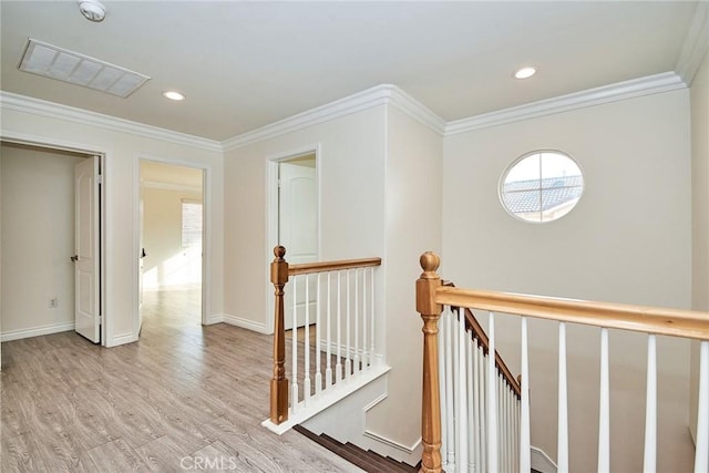 hall featuring light hardwood / wood-style floors and ornamental molding