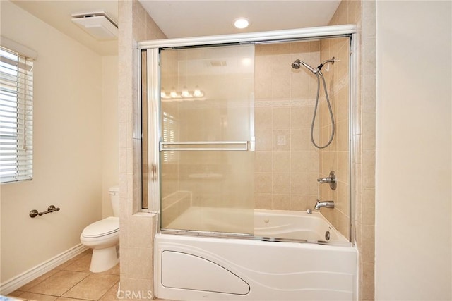 bathroom with tile patterned flooring, toilet, and bath / shower combo with glass door