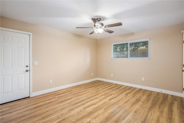 spare room with ceiling fan and light hardwood / wood-style flooring