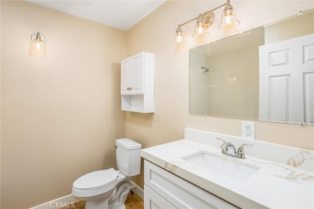 bathroom featuring toilet and vanity