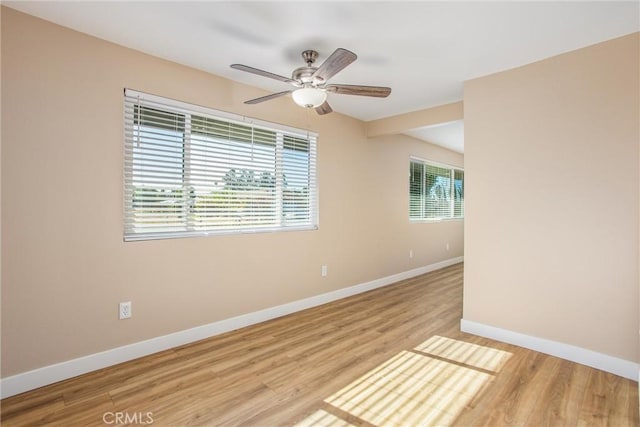 unfurnished room with ceiling fan and light wood-type flooring