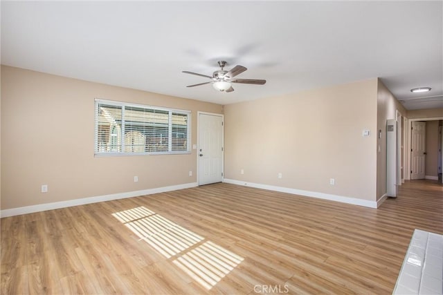 empty room featuring ceiling fan and light hardwood / wood-style flooring