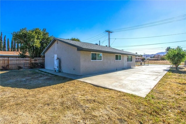 back of property featuring a yard and a patio