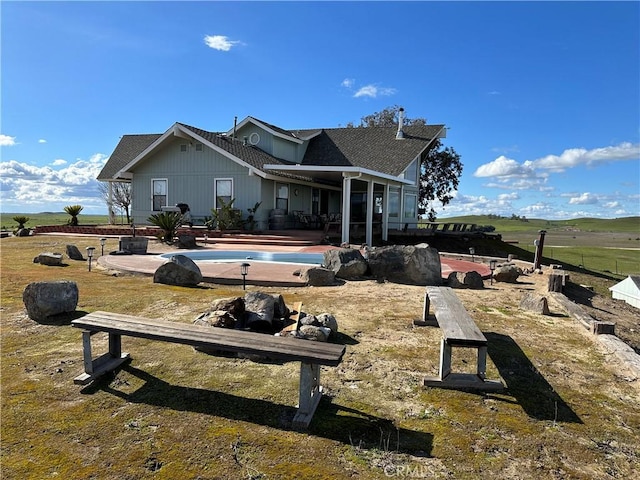 back of house featuring a rural view and a patio