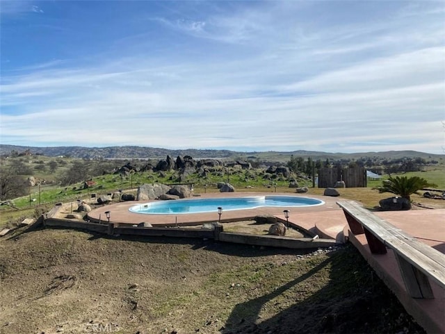 view of swimming pool featuring a mountain view