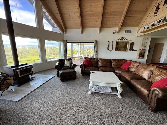 carpeted living room with beam ceiling, wood ceiling, a wood stove, and high vaulted ceiling